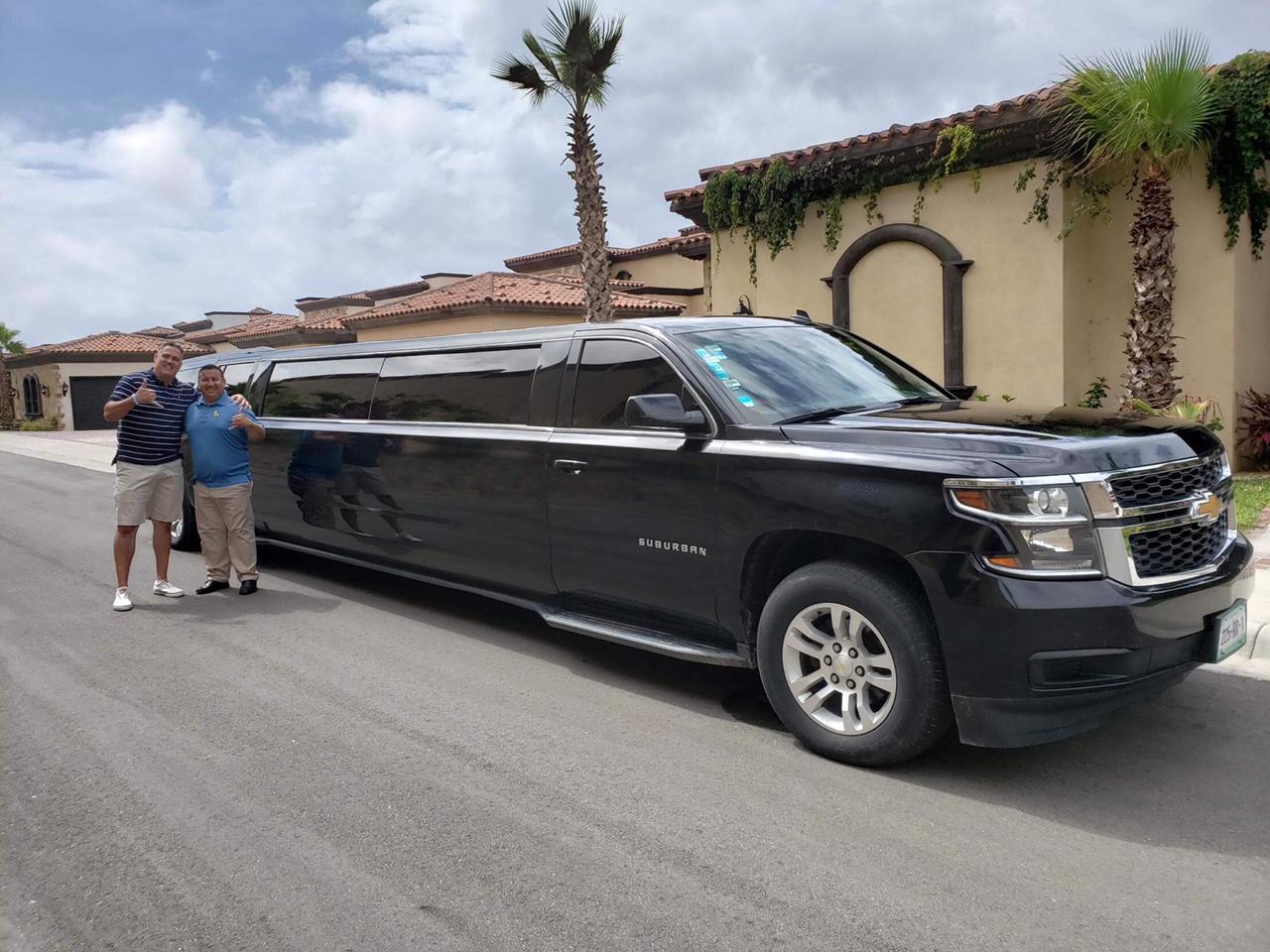 Cabo Airport Shuttles driver greeting a client beside a private SUV