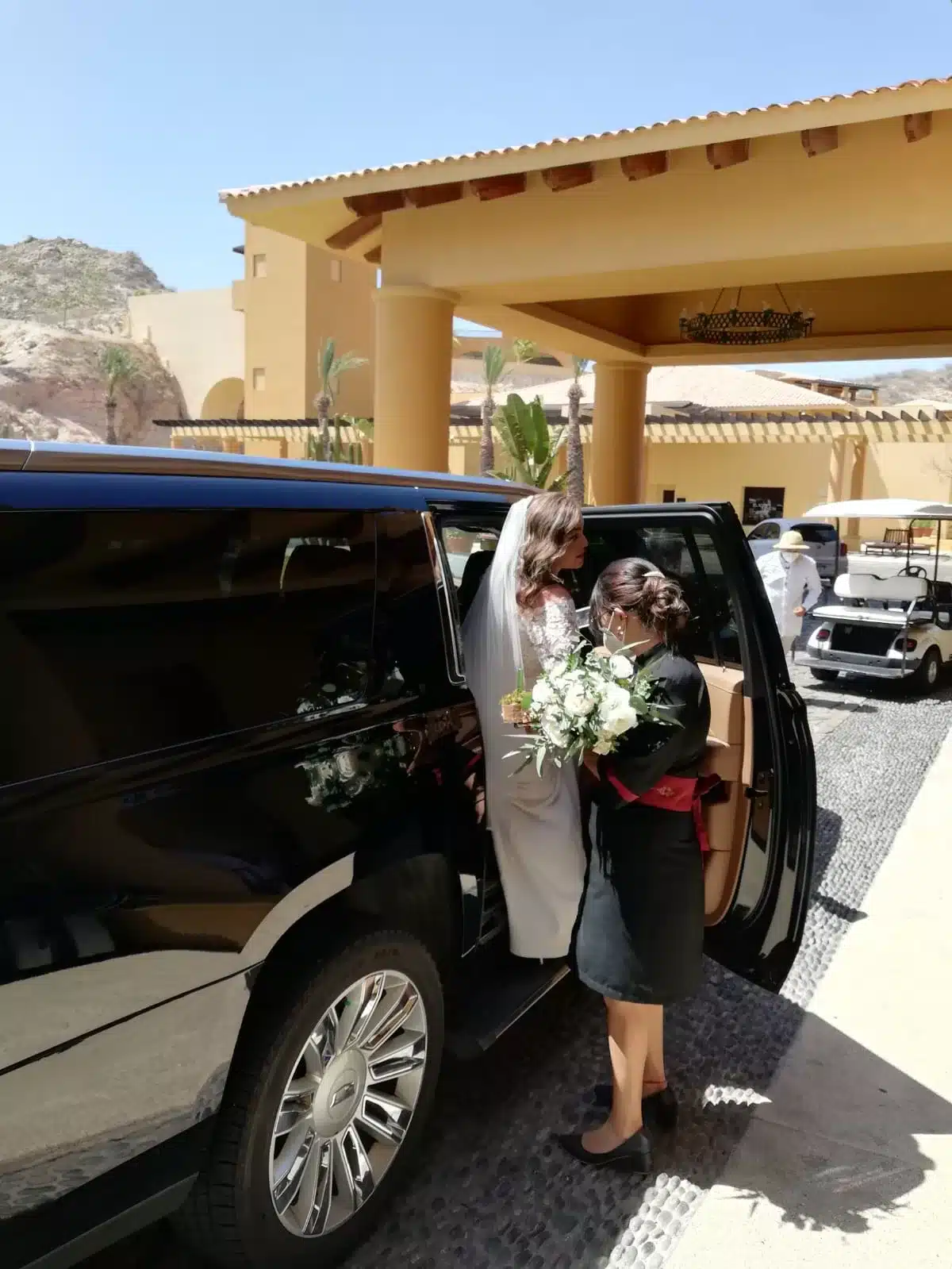 Bride boarding a private SUV for wedding transportation in Los Cabos